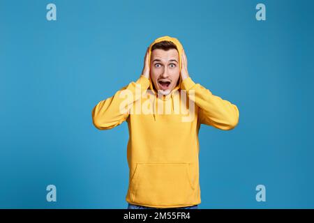 shocked man with round eyes, open mouth and hands Stock Photo