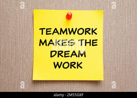 Motivational business quote Teamwork Makes The Dream Work written on a yellow sticky note. Stock Photo