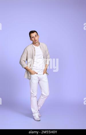 man in casual shirt posing on purple background. Stock Photo