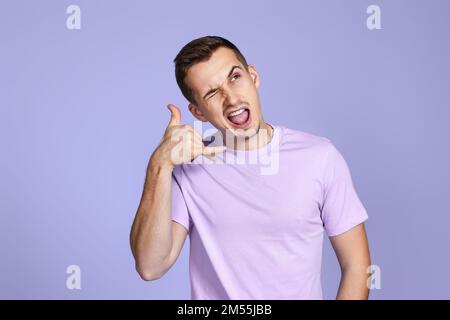 man doing phone gesture with hand like talking on the telephone Stock Photo