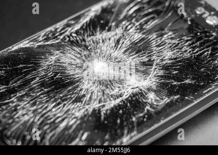 Smashed crushed smartphone with broken cracked display close up Stock Photo