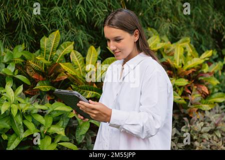 Attractive young woman freelancer using digital tablet in outdoor Stock Photo