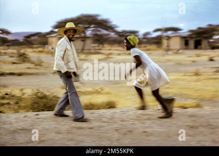 Ethiopia, 1970s, Adami Tulu, man with hat having fun with a young woman, after sunset, Oromia region, East Africa, Stock Photo