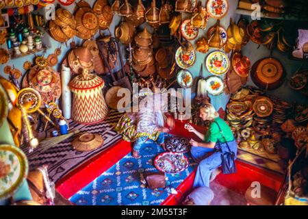 Ethiopia, 1970s, Harar, Caucasian blond woman shopping by local crafts store, Harari region, East Africa, Stock Photo