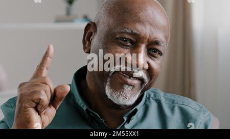 Old bald bearded middle-aged man African grandfather biracial businessman with gray beard looking at camera, waving head agree approve good business Stock Photo
