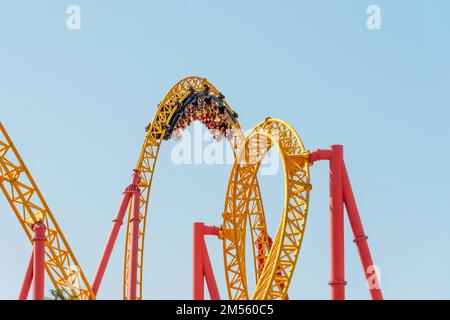 Roller coaster up down turn and a passing loop feint, spiral train of trolleys tends to go down Stock Photo