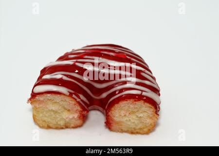 Strawberry flavor ring donut with white chocolate sauce, glazed, yeast raised, American style ring doughnut, type of food made from leavened deep frie Stock Photo