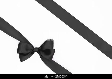 Satin ribbon bow for gift pack in grey color, isolated on white ...