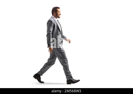 Full length profile shot of a young professional man walking isolated on white background Stock Photo
