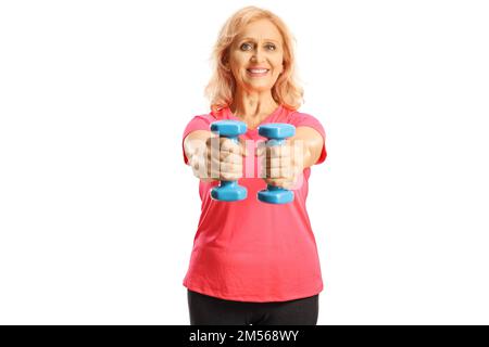 Smiling mature woman exercising with blue dumbbells isolated on white background Stock Photo