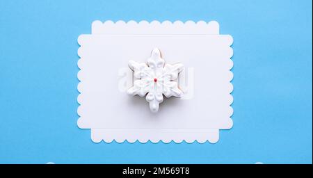 Gingerbread in the shape of a snowflake on a blue background. Stock Photo