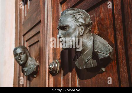 Heads sculptures on the main door of St. Mary's Basilica in Krakow, Poland. Close-up. Stock Photo