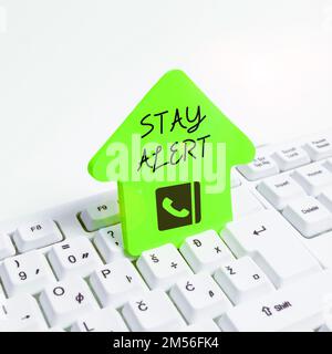 Hand writing sign Stay Alert. Word Written on Paying full attention to things around Quick to see or understand Stock Photo