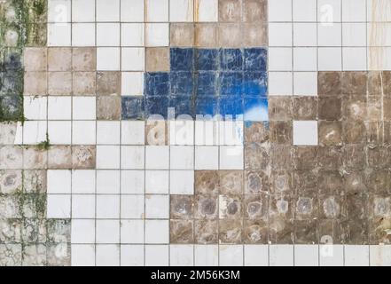 dirty white tile with chipped edges on the wall Stock Photo