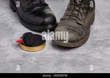 Before and after of polished and dirty leather work boots. Shoe polish, footwear care and cleaning. Stock Photo