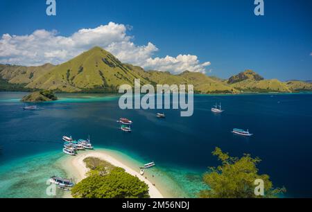 A beautiful view of Kelor island and boats in the sea in East Nusa Tenggara, Indonesia. Stock Photo