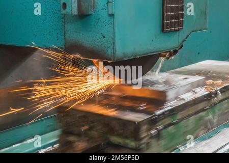 The automatic grinding machine polishes the part on a movable platform Stock Photo