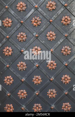 background of ancient metal forged doors in the castle Stock Photo