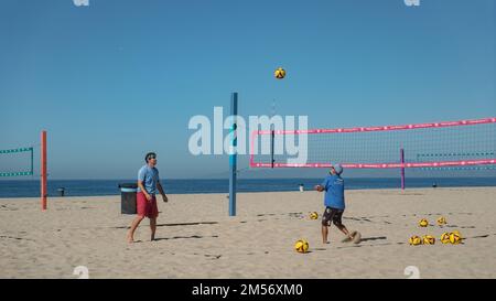 Two men playing beach volley in Hermosa Beach. Stock Photo
