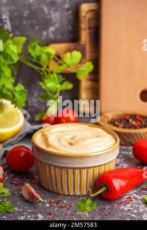 Bowl of tasty chipotle sauce on grunge background Stock Photo