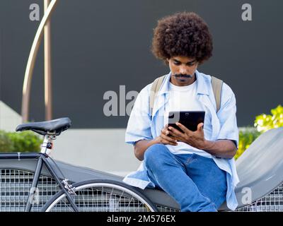 Entrepreneurial young African American man working with a tablet in a financial district Stock Photo