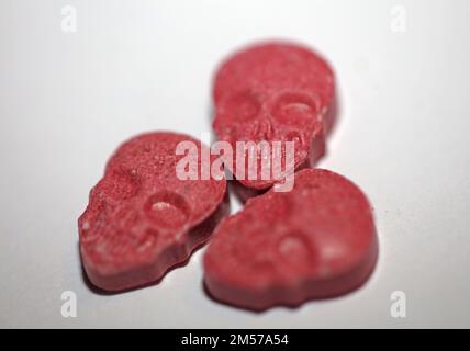 Purple skull world's strongest ecstasy pills close up background high quality big size dope print Stock Photo