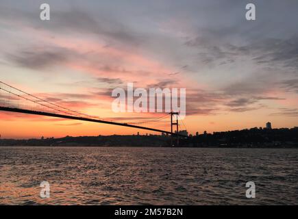 Sunset at July 15 Martyrs Bridge (Bosphorus Bridge) in Istanbul, Turkey. Stock Photo