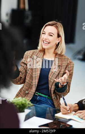 Every point is on point. a young woman having a discussion with her colleagues during a meeting. Stock Photo