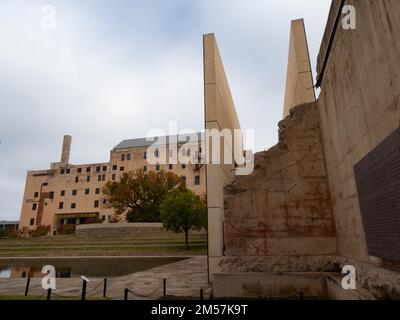 Low-angle view of the only remaining wall from the Alfred P. Murrah Federal Building with the Gates of Time and the Oklahoma City National Memorial an Stock Photo