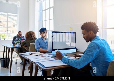 Entrepreneurs doing what they do best. a team of young professionals at work in a modern office. Stock Photo