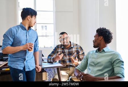 Innovators never stop planning. a team of young entrepreneurs having a discussion in a modern office. Stock Photo