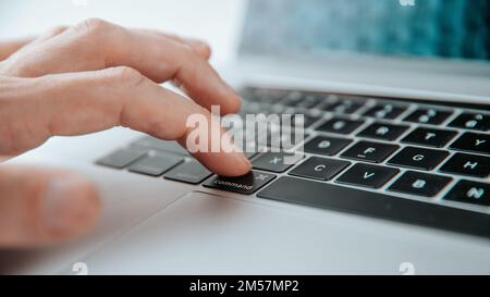 close up. man pressing the command key on his laptop. Belarus, Minsk - July 13, 2020: Apple Inc. product design Space gray Macbook Pro Stock Photo