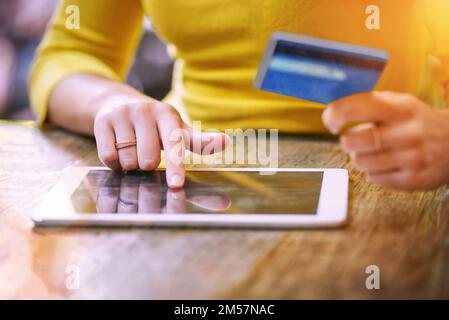 Browsing for sales the simple way. an unrecognizable young woman shopping online. Stock Photo