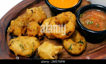 traditional indian snack food, crispy deep fried vada and chutneys close up in a serving plate Stock Photo