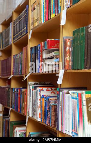 Chapaevsk, Samara region, Russia - December 24, 2020: Books on a shelf in the library. Selective focus Stock Photo