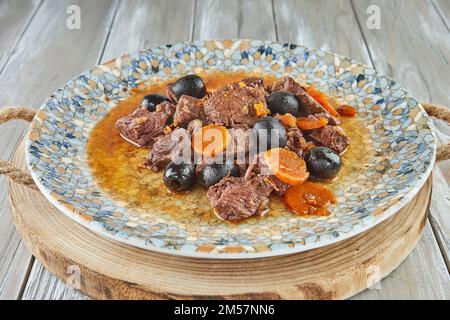 Daub Provencal meat stew on plate on wooden background Stock Photo