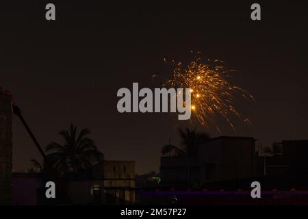 firework during celebration of new year, diwali and other festivals. shot taken against night sky. Stock Photo