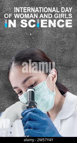 Asian scientists use microscopes. International Day of Women and Girls in Science Stock Photo