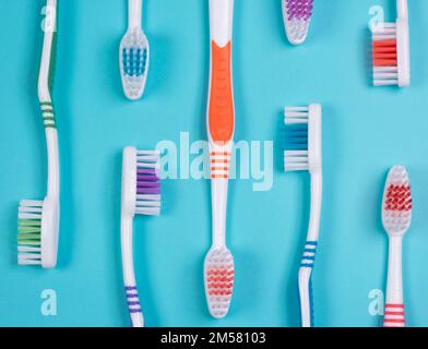 background dental toothbrushes of different colors on a blue background top view.  Stock Photo