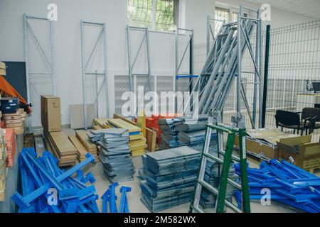 product warehouse in the store. Shelves in the back room. Retail Warehouse full of Shelves with Goods in Cardboard Boxes and Packages. Logistics, Sorting and Distribution Facility for Product Delivery. High quality photo Stock Photo