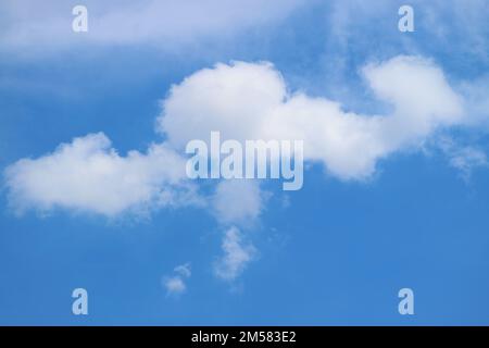 White Fluffy Clouds Floating on Bright Blue Sky Stock Photo