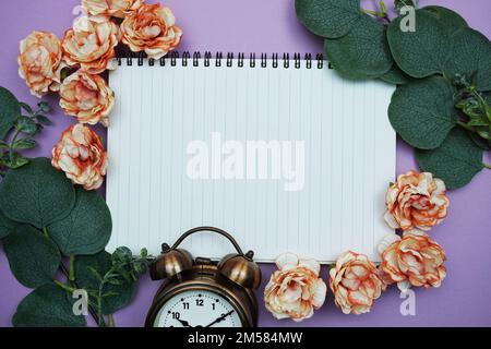 Mockup of Empty notebook page for copy with Eucalyptus leaves on purple background Stock Photo