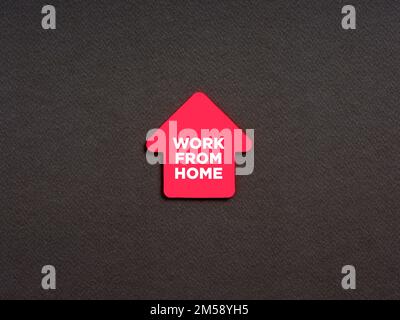 The message work from home written on a house shaped note paper. Freelance working from home concept. Stock Photo