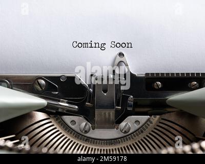 The announcement message coming soon written with a vintage typewriter. Stock Photo