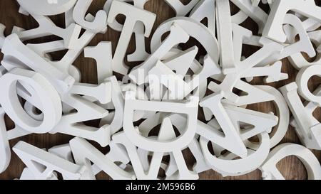 random white wooden alphabet letters top view on purple background Stock Photo