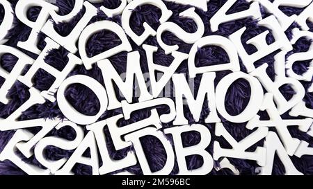 random white wooden alphabet letters top view on purple background Stock Photo