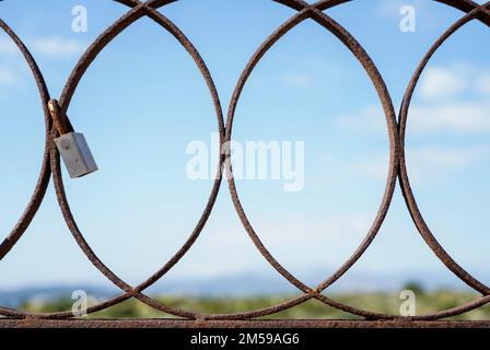 Padlocks attached to an old rusty iron door Stock Photo