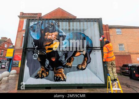 England, Dorset, Bournemouth, Boscombe, Council Worker Cleaning Street Art titled 'The Sausage Dog' by the Artist Tech Moon *** Local Caption ***  UK, Stock Photo