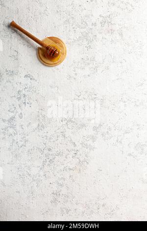 Natural honey spoon on empty concrete background with copy space Stock Photo