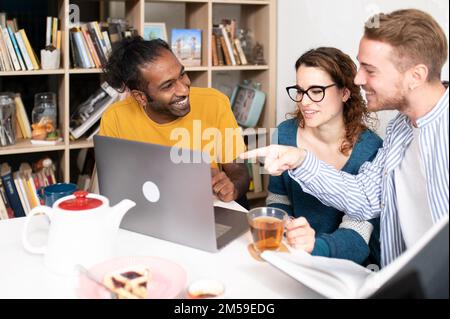 Generation z multiracial students at caferia, group of young people friends enjoying breakfast at indoors restaurant, having fun talking and joking to Stock Photo